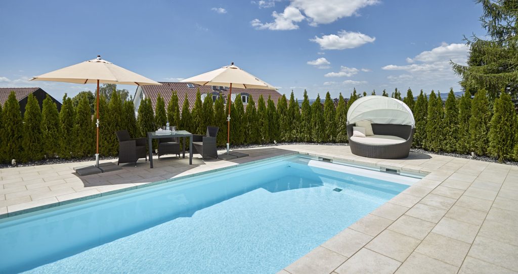 02_pool-wohlfuehloase-poolbau-schwimmbecken-tuerkis-liegemuschel-sonnenschirm