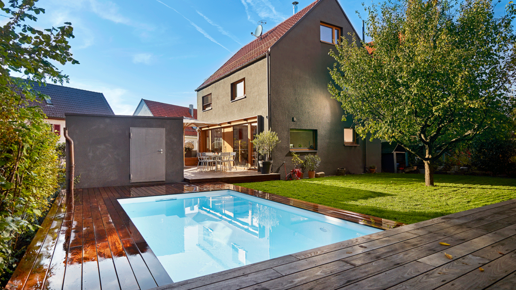 Kleiner Outdoorpool mit Holzterrasse.